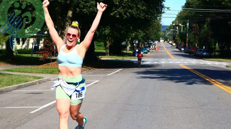 “Crowds cheering relay teams during Harper’s 10K livestream handoff point”