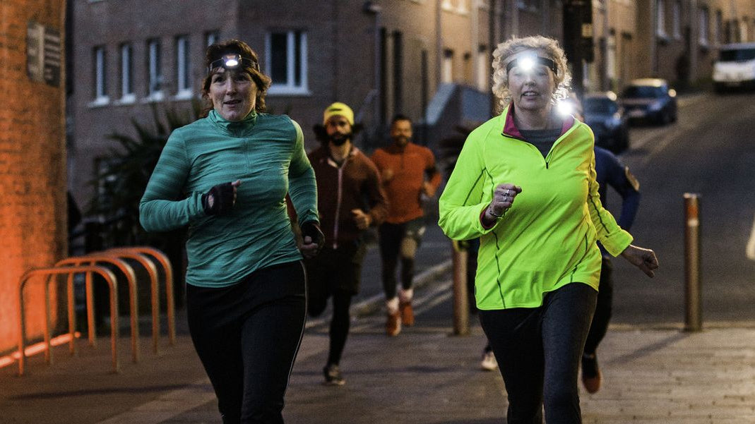 Runners using headlamps and reflective apparel during their night workout