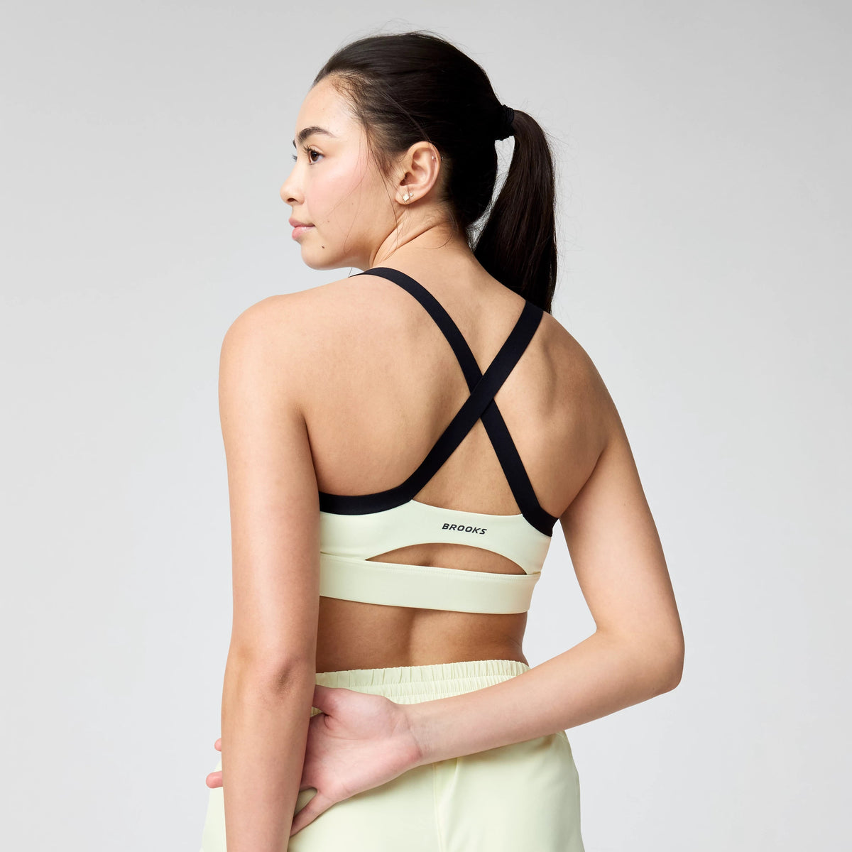 Women's Brooks Luxe Strappy Sports Bra in Luminary/Black, back view.