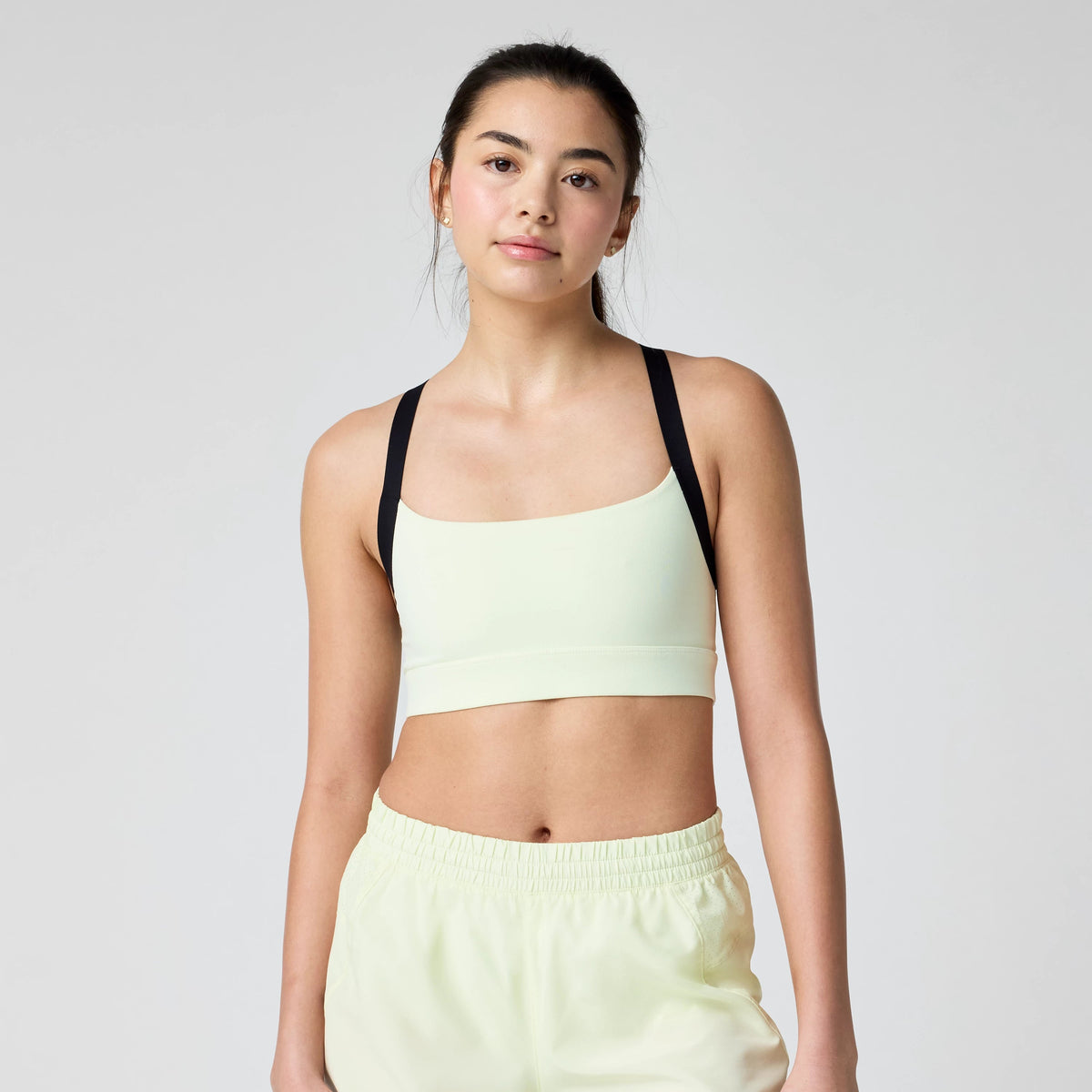 Women's Brooks Luxe Strappy Sports Bra in Luminary/Black, front view.