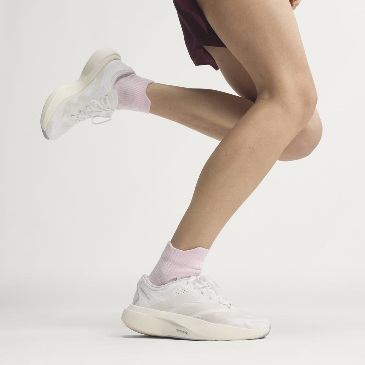 Adidas Adizero Evo SL Exo women's running shoe in Cloud White/Zero Metalic/Core White — on-foot side view