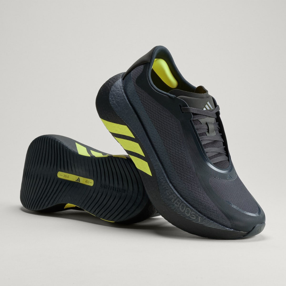Adidas Hyperboost Edge men's running shoe in Carbon/Hi-Res Yellow/Grey Five — angled pair with outsole visible