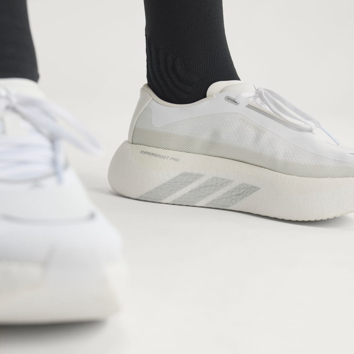 Adidas Hyperboost Edge women's running shoe in Cloud White/Silver Metallic/Zero Metalic — on-foot side detail