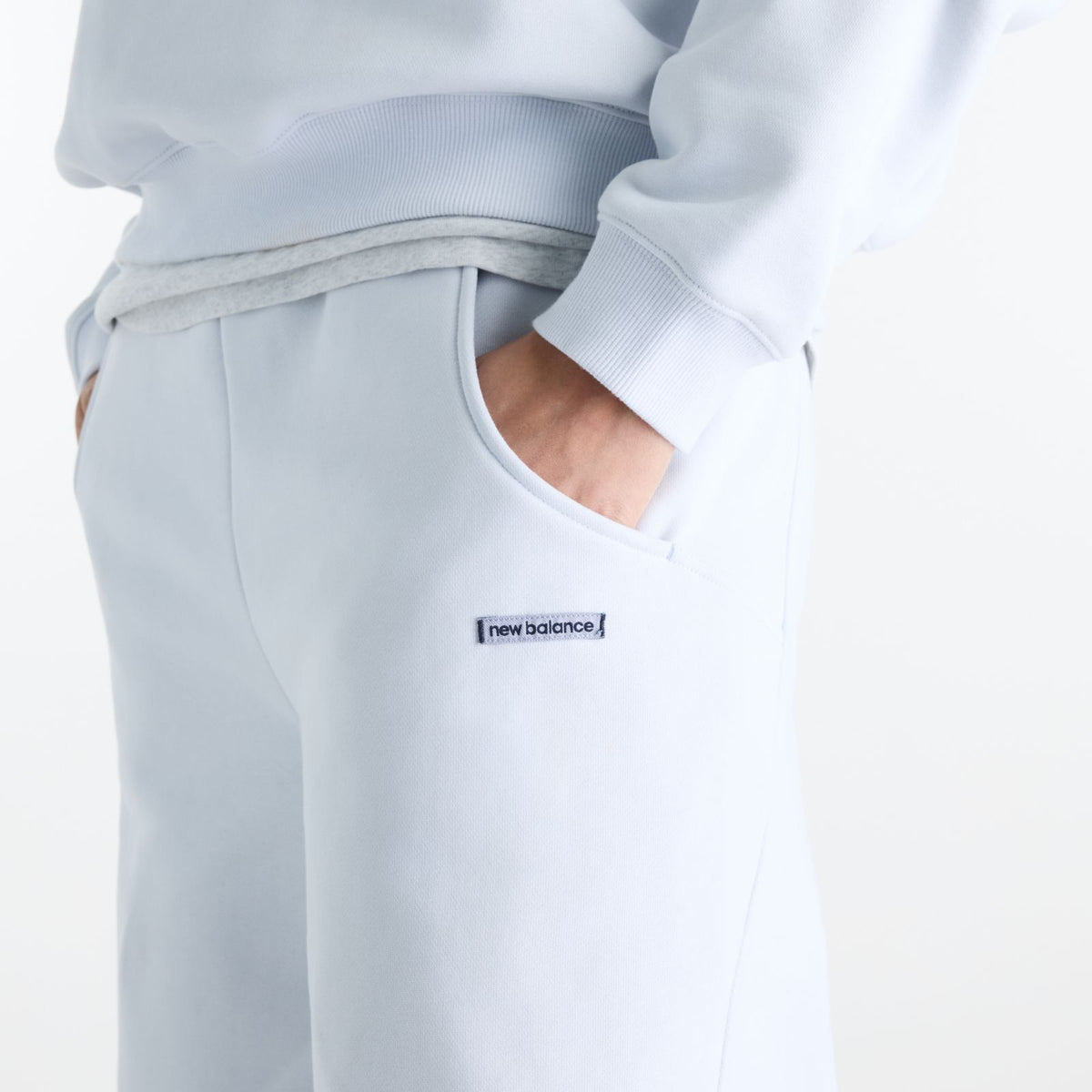 Woman wearing New Balance Sydney Levrone Athletics Crafted Pant in Fresh Air side view