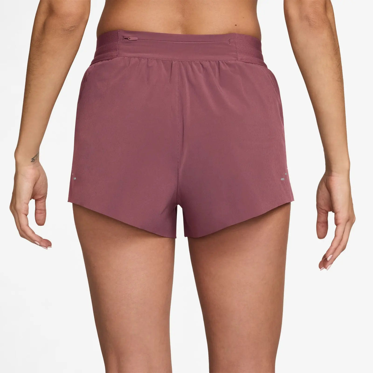 Women's Nike Dri-FIT Mid-Rise 2.5-inch Running Shorts in Pink Rise, rear view.