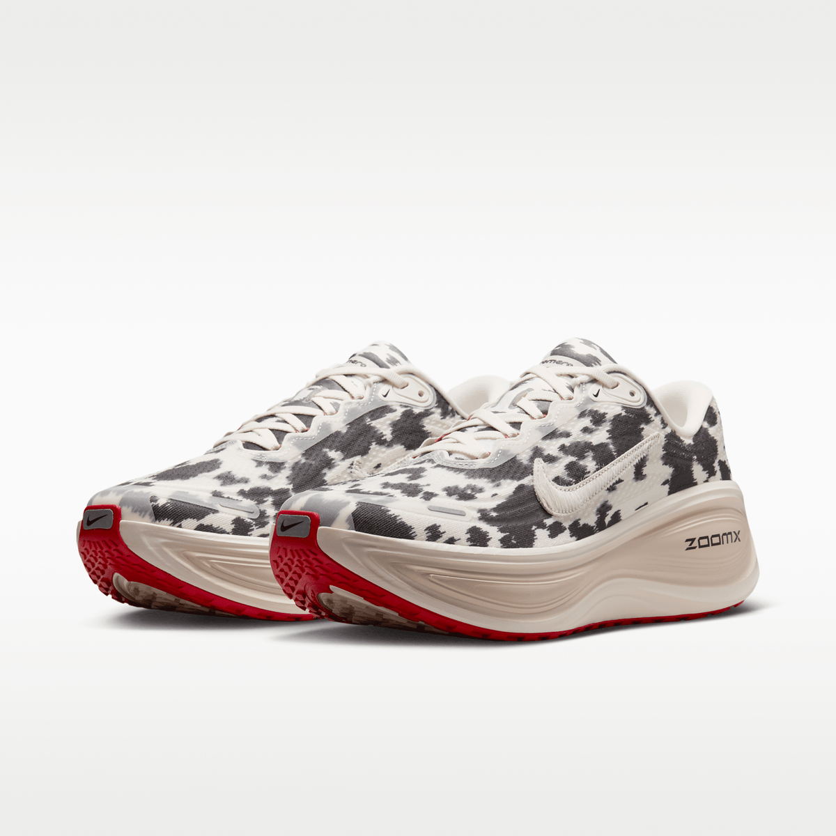 Nike Vomero Plus men's shoes in Sail/Black/University Red with animal-print upper — front three-quarter view of the pair.