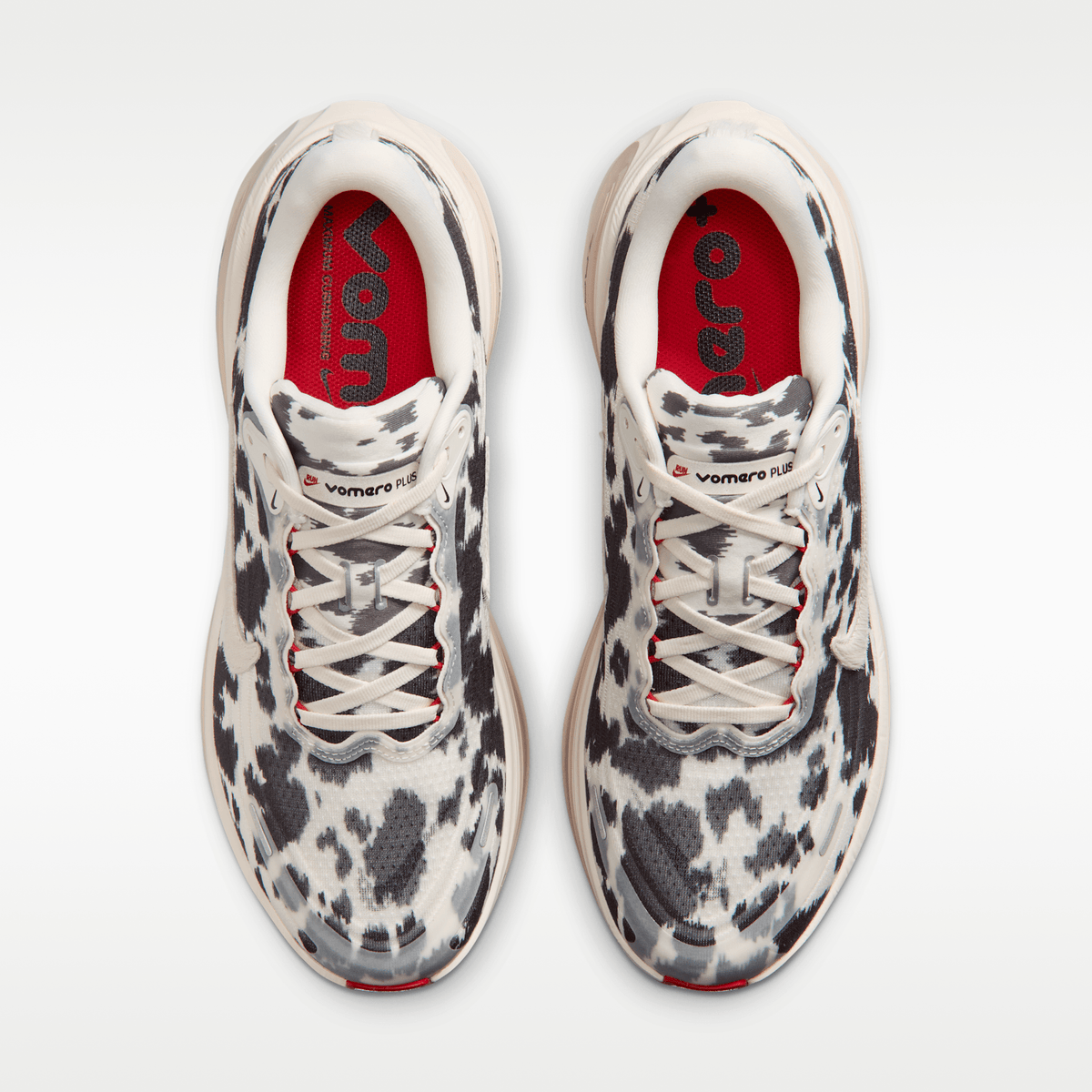Nike Vomero Plus men's shoes in Sail/Black/University Red with animal-print upper — top view of the pair.
