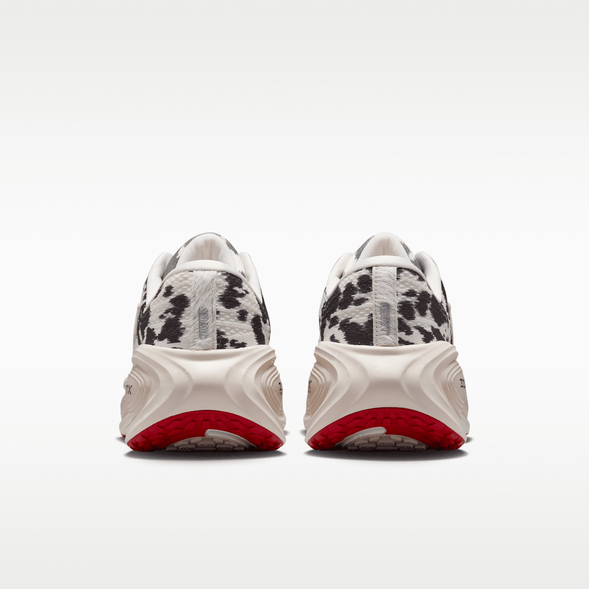 Nike Vomero Plus men's shoes in Sail/Black/University Red with animal-print upper — rear view of the pair.