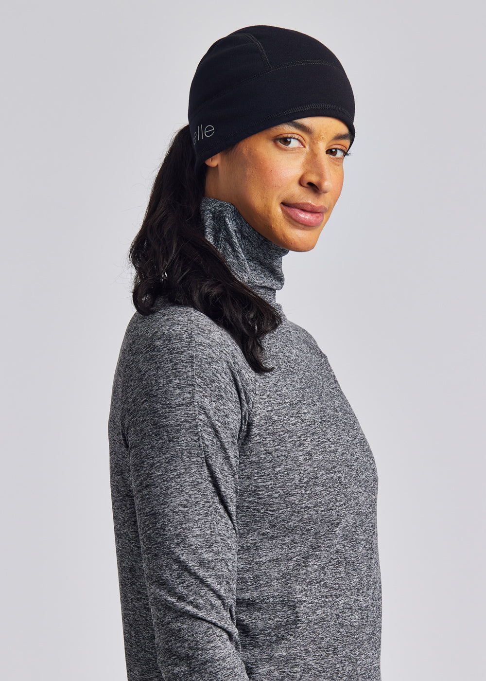 Women's Oiselle Power Move Beanie in Black, rear ponytail opening detail.