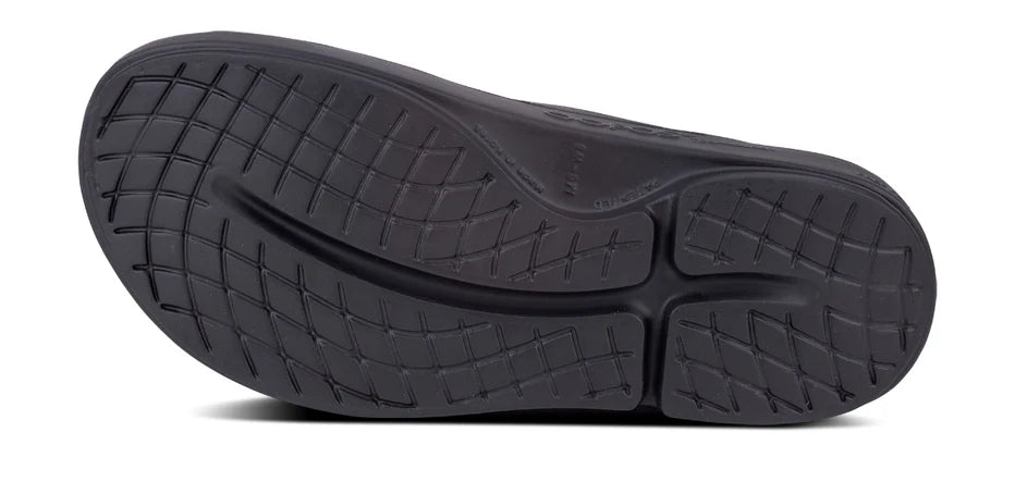 Oofos Ooahh Slide. Black. Bottom view.