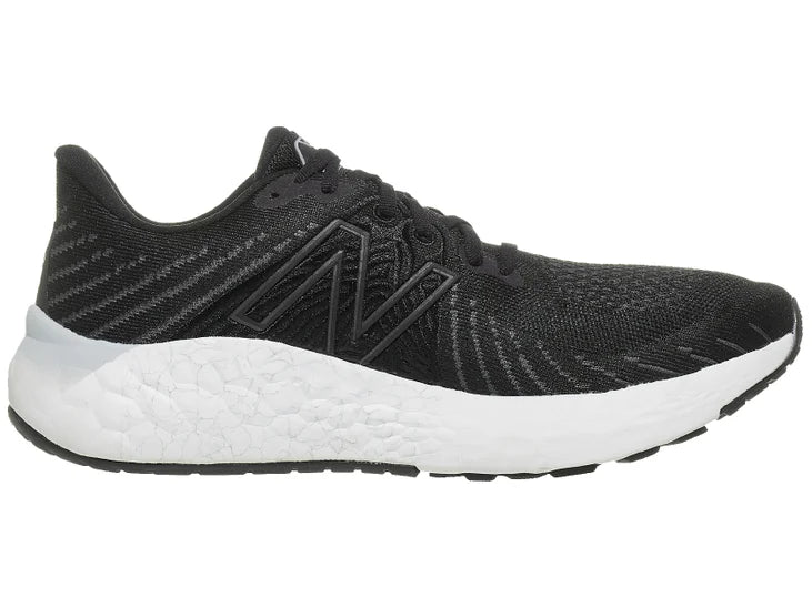Men's New Balance Vongo V5. Black upper. White midsole. Medial view.