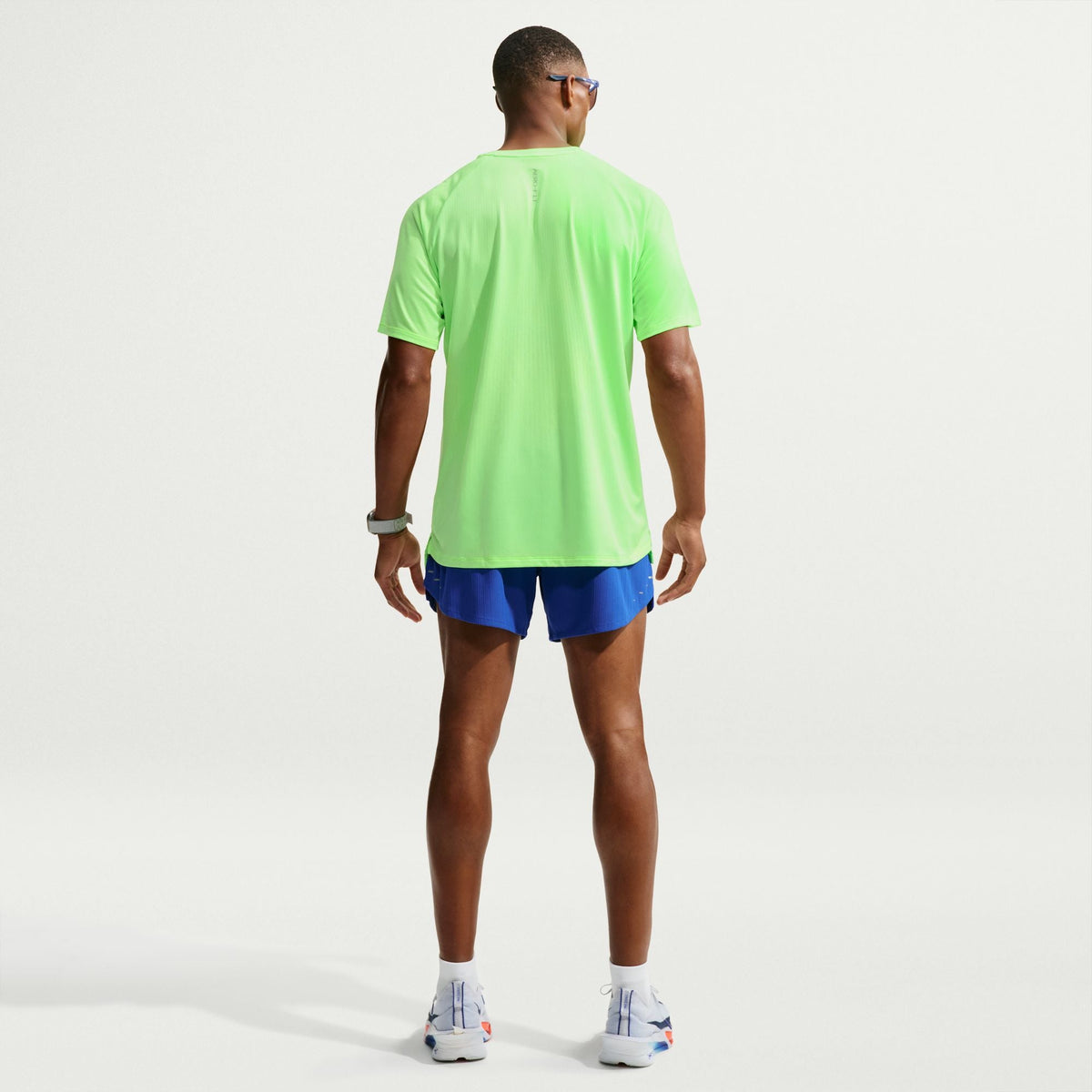 Men's Nike Stride Aero-Fit Short Sleeve Running Shirt in Volt/Light Silver, rear view.