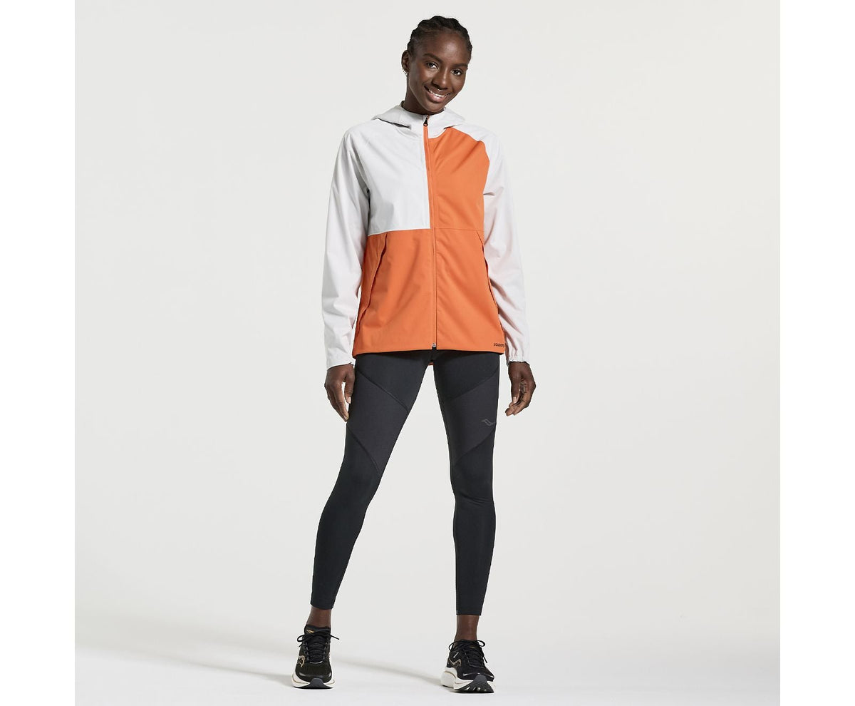 Women's Saucony Boulder Drizzle Jacket. Orange/White. Front view.