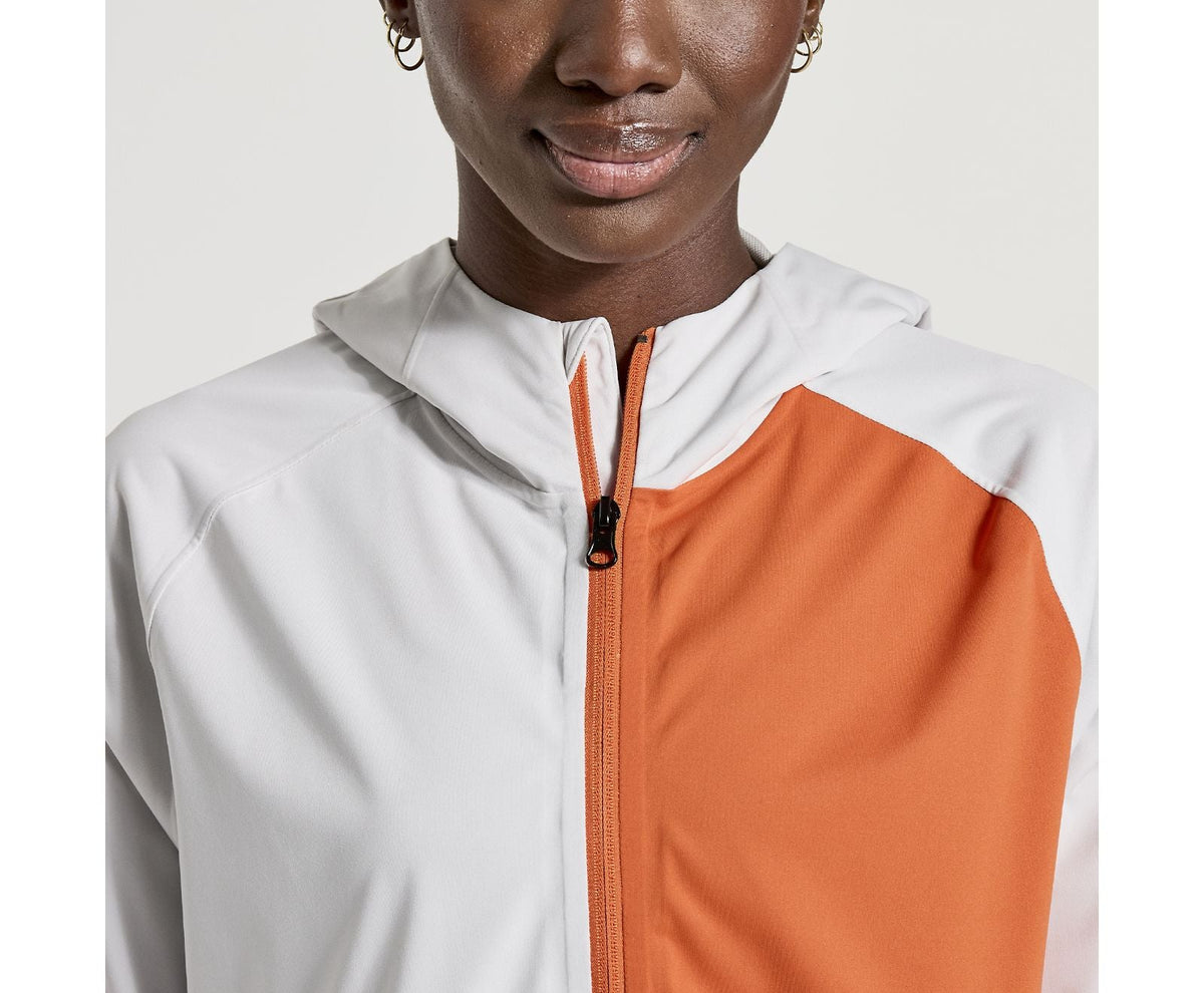 Women's Saucony Boulder Drizzle Jacket. Orange/White. Front view.