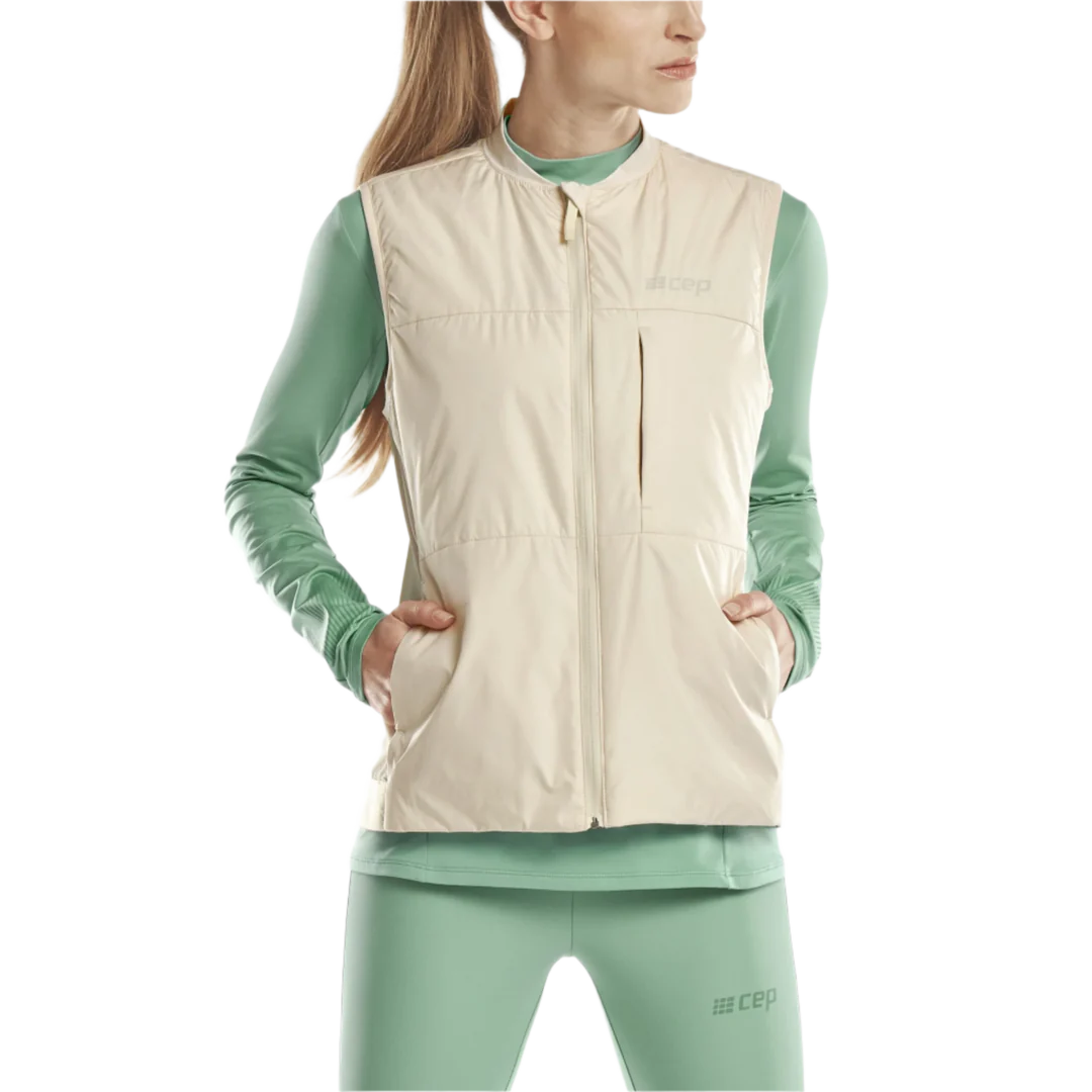 CEP Cold Weather Reversible Vest. Women's. Cream. Front view on model.