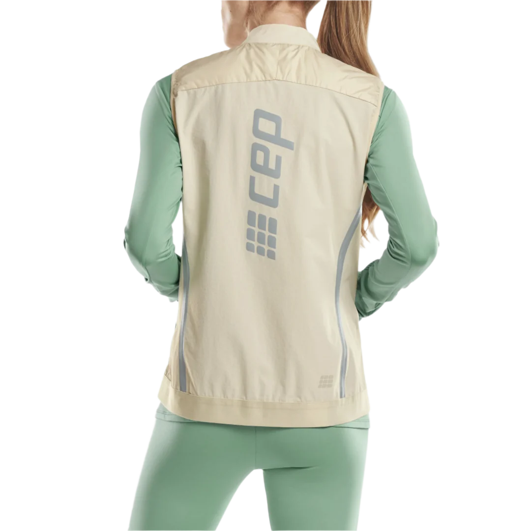 CEP Cold Weather Reversible Vest. Women's. Cream. Back view on model.