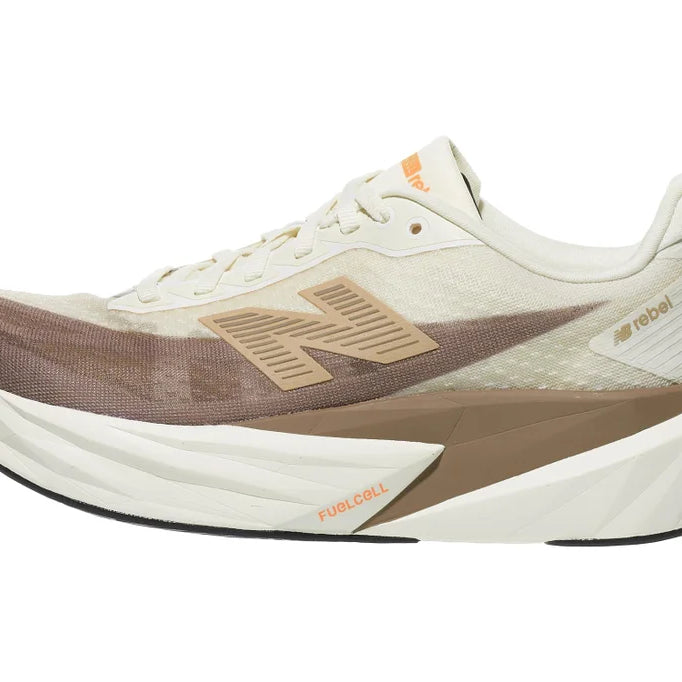 Women's New Balance Rebel v5. Off White/Tan upper. Off White/Tan midsole. Lateral view.