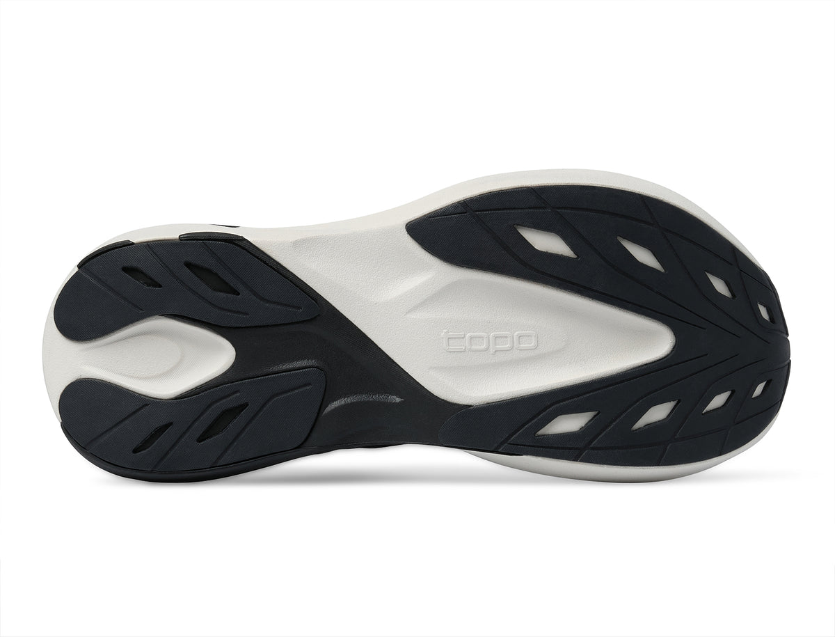 Women's Topo Aura 2. Black upper. White midsole. Bottom view.