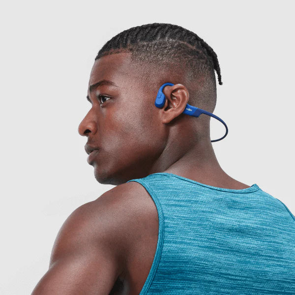 Shokz OpenRun Headphones Blue shown on male model.