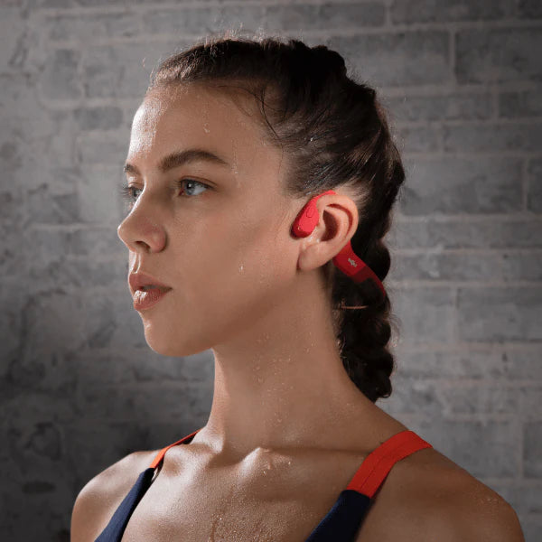 Shokz OpenRun Headphones Red on a female model.
