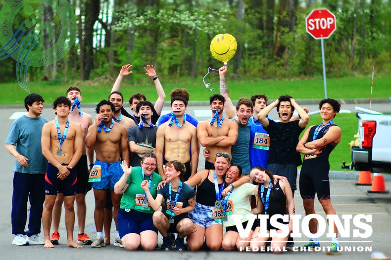 Binghamton University HWS Triathlon class poses together after completing the 2025 Spring Triathlon, celebrating with medals and smiles on campus.