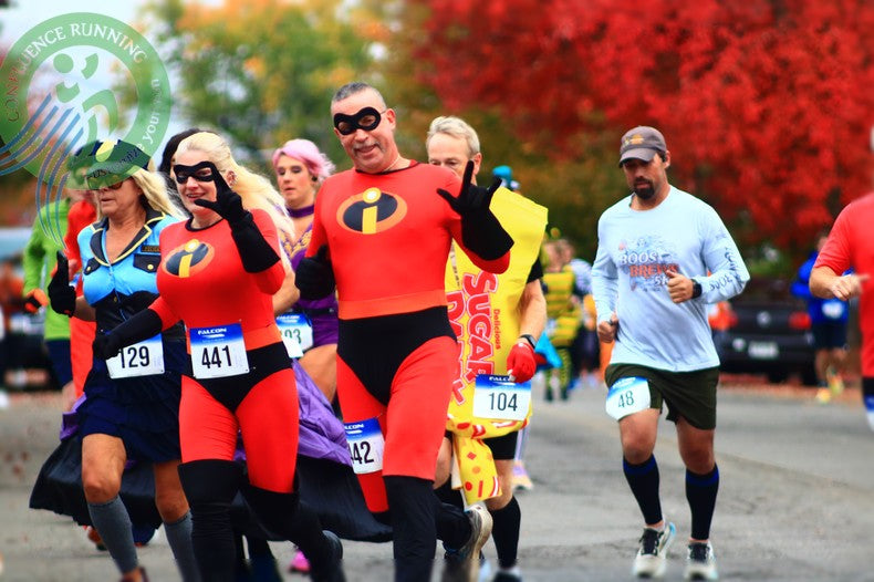 The Incredibles Costumes Runners in costumes — witches, superheroes, and pumpkins — starting the Halloween 13k