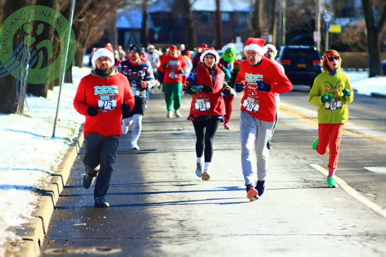 Binghamton Sanata Run participants running down riverside drive in Binghamton New York 400 runners and racers