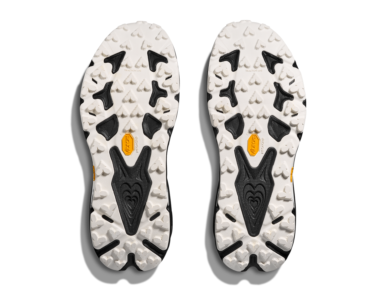 Women's Hoka Speedgoat 7. White/Black upper. Black midsole. Bottom view.