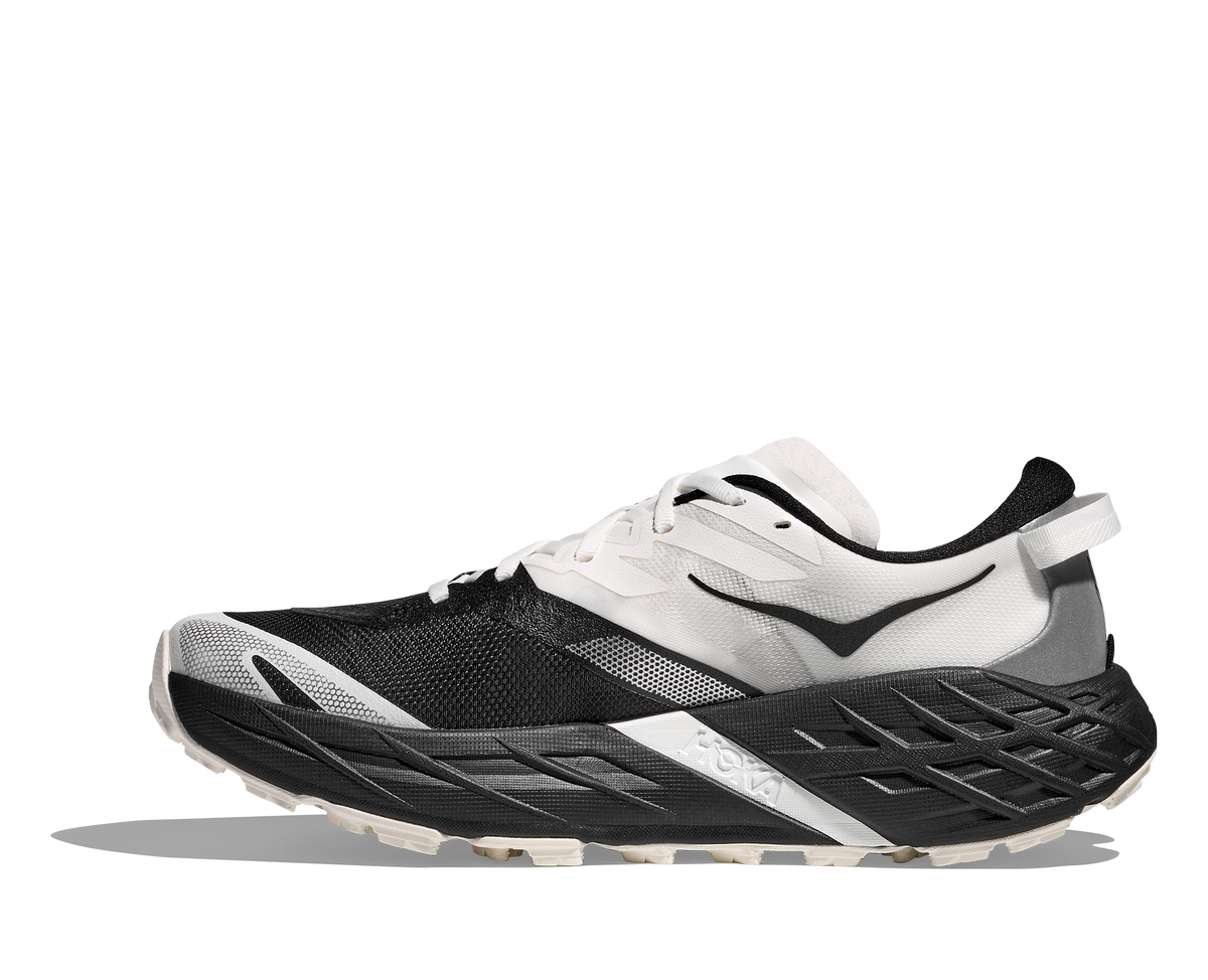 Women's Hoka Speedgoat 7. White/Black upper. Black midsole. Medial view.