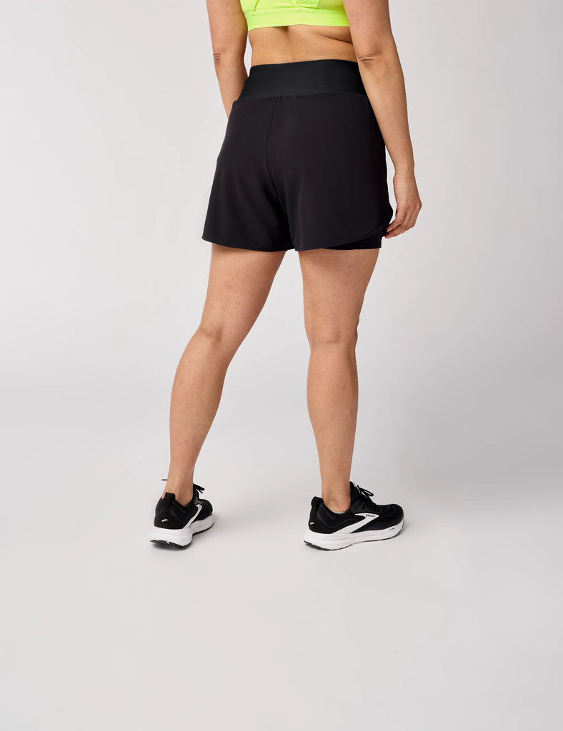 Women's Brooks Chaser 5" 2-in-1 Shorts. Black. Rear view.