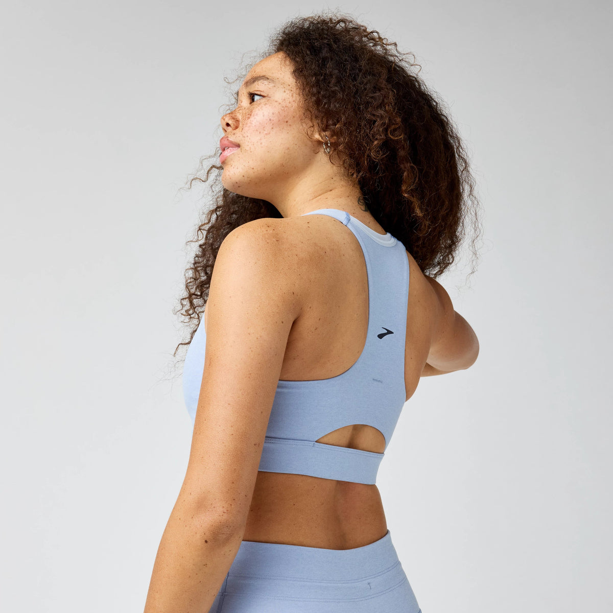 Women's Brooks Luxe Pocket Sports Bra in Heather Halogen Blue, back view