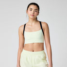 Women's Brooks Luxe Strappy Sports Bra in Luminary/Black, front view.