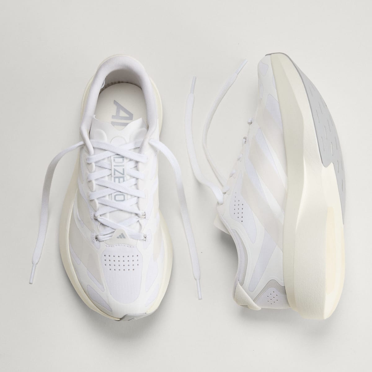 Adidas Adizero Evo SL Exo women's running shoe in Cloud White/Zero Metalic/Core White — top and opposite side views