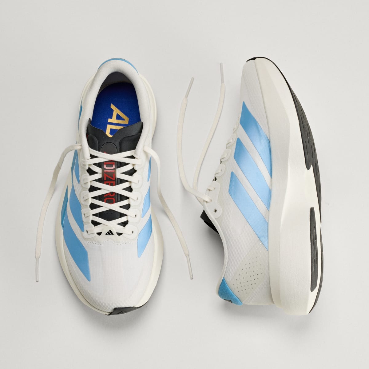 Adidas Adizero Evo SL Woven women's running shoe in Off White/Light Blue/Off White — top and opposite side views