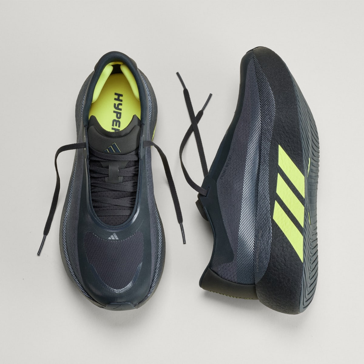 Adidas Hyperboost Edge men's running shoe in Carbon/Hi-Res Yellow/Grey Five — top and opposite side views