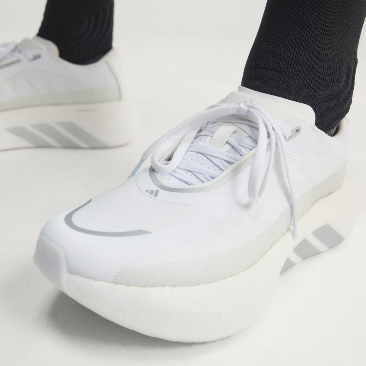 Adidas Hyperboost Edge women's running shoe in Cloud White/Silver Metallic/Zero Metalic — upper and lacing close-up