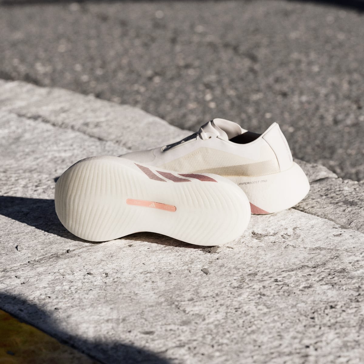 Adidas Hyperboost Edge women's running shoe in Off White/Vapour Pink/Matte Silver - outsole and side view