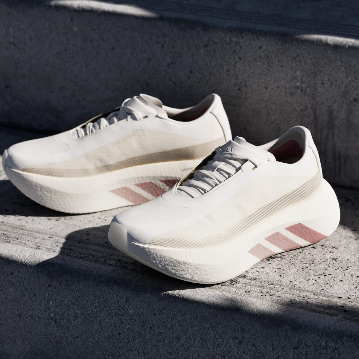 Adidas Hyperboost Edge women's running shoe in Off White/Vapour Pink/Matte Silver - angled pair on pavement