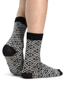 Bjoroy crew socks in Black/Off White worn as a pair, showing the Nordic rose pattern
