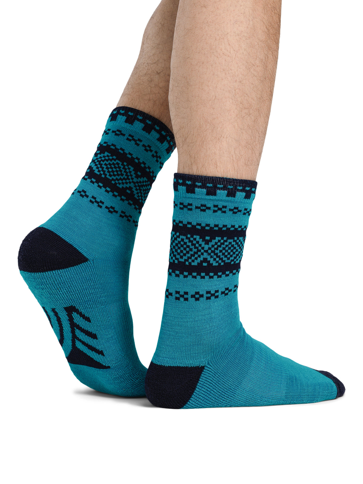 Dale of Norway Cortina unisex crew socks in turquoise and navy, pair shown on feet