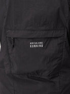 New Balance women's Impact Run Jacket in Black, packable rear pocket detail