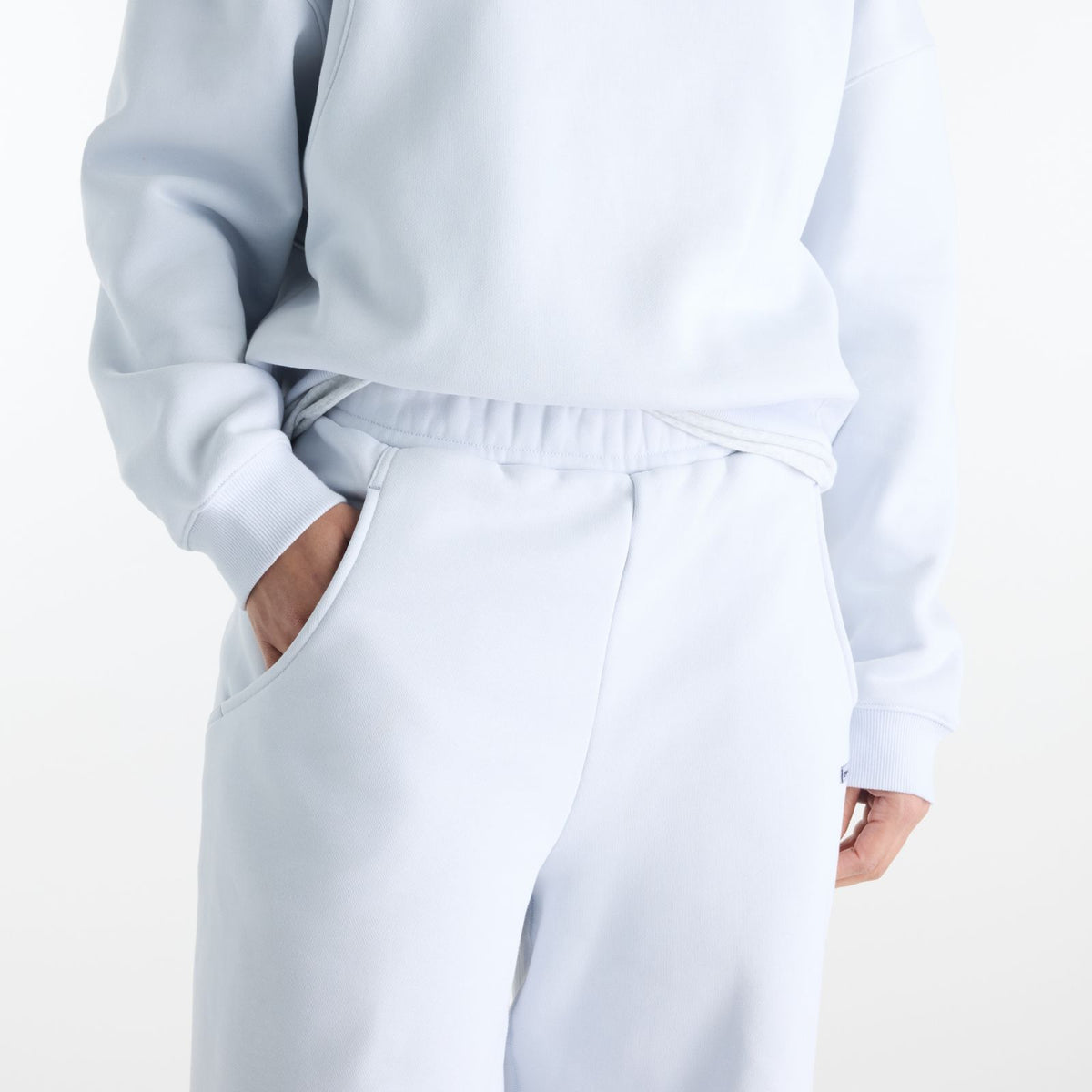 Woman wearing New Balance Sydney Levrone Athletics Crafted Pant in Fresh Air view 1