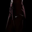 Women's Nike Dri-FIT Mid-Rise 2.5-inch Running Shorts in Pink Rise, reflective details shown in low light.