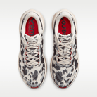 Nike Vomero Plus men's shoes in Sail/Black/University Red with animal-print upper — top view of the pair.