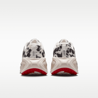 Nike Vomero Plus men's shoes in Sail/Black/University Red with animal-print upper — rear view of the pair.