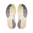 On Running Cloudsurfer Max women's running shoe in Dijon/Ivory — outsole view of the pair
