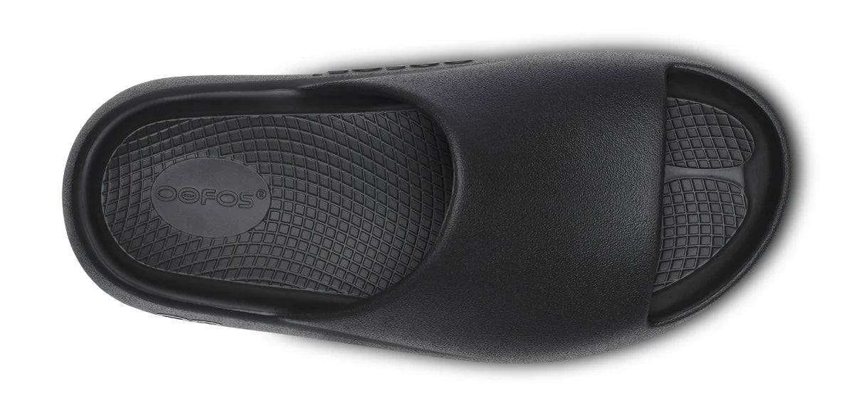 Unisex Oofos OOahh PLUS Slide in Black, top view.