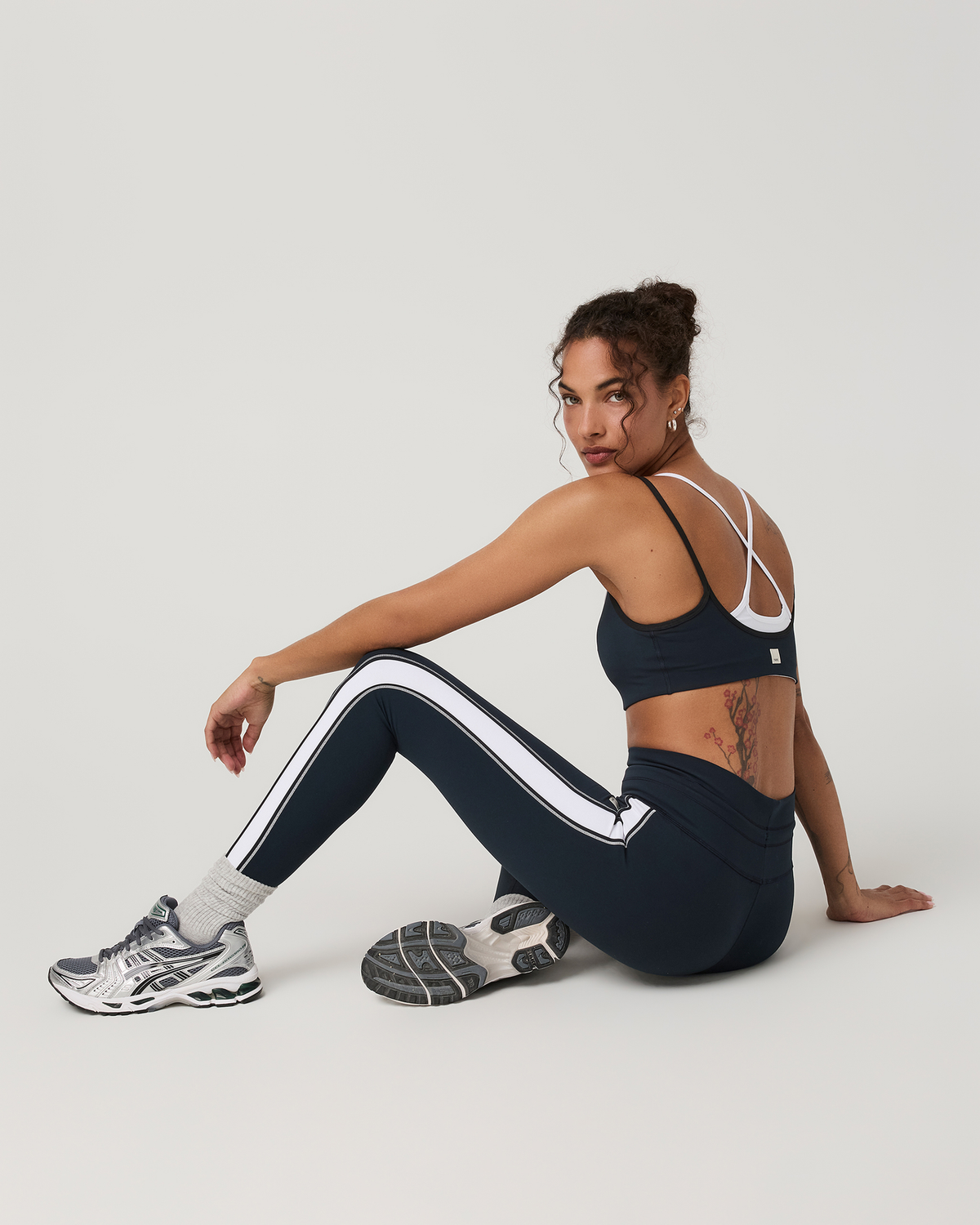 Vuori Daily Layered Bra women's sports bra in Ink — back view in a seated pose