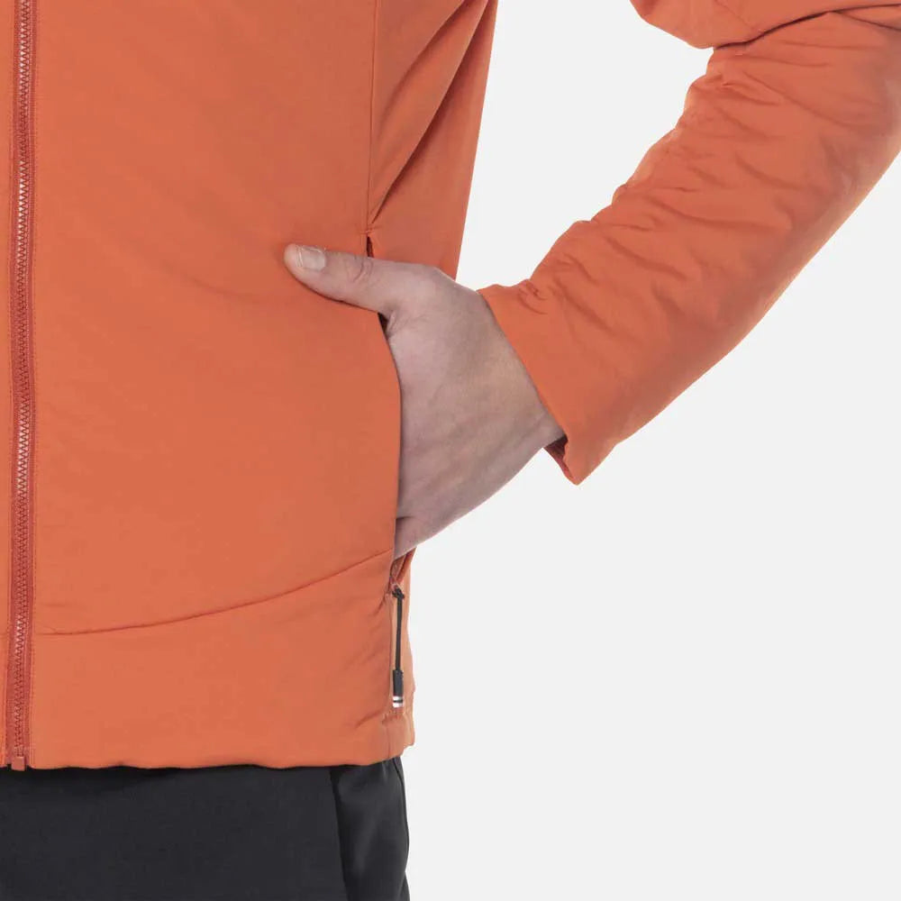 Person wearing an orange jacket with a hand in the pocket on a white background