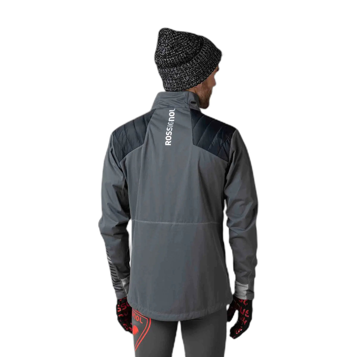 Person wearing a gray jacket with 'ROSSIGNOL' branding on the back, standing against a white background.